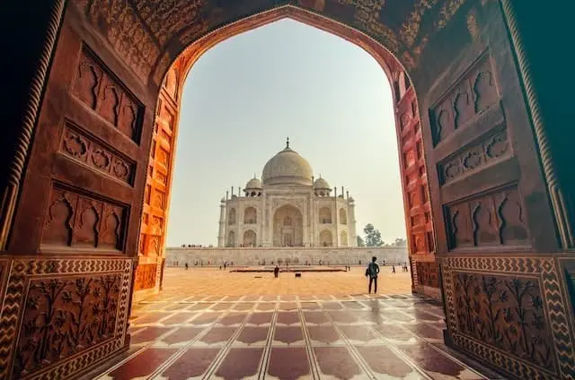Taj Mahal viewed through a traditional Indian architectural gateway