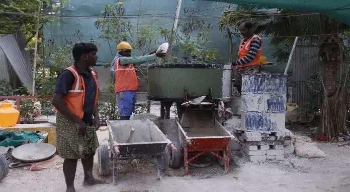 Construction workers preparing traditional lime plaster